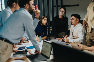 Multicultural business colleagues engage in a creative brainstorming session, highlighting...