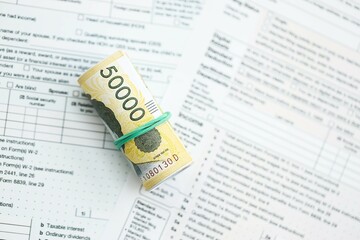 South Korean won money bills in big amount lies on table with tax forms close up