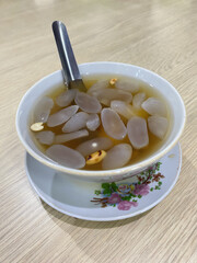 Wedang Ronde, Indonesian Peranakan Dessert Made from Glutinous Ball Dumpling with Sweet Ginger Infuse Syrup or Palm Sugar Syrup. Served on Bowl with Traditional Flowers Pattern
