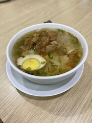 Timlo Soup is Authentic from Solo, Central Java, Indonesian. Made from Chicken, glass noodles, egg, Sosis Solo and Served with hot Clear Chicken Broth. Served on white Bowl.
