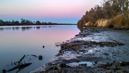Tranquil Riverbank at Sunset with Soft Colors and Natural Landscape