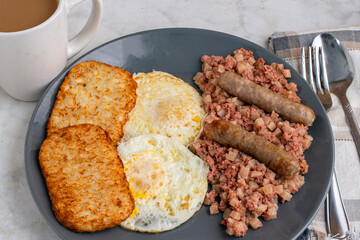 eggs ove easy  with corn beef hash and sausage