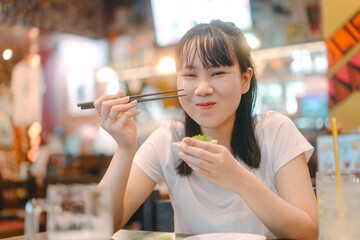 Asian woman eating food at izakaya japanese bar and restaurant Japan dinner culture relax time