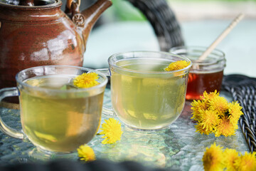 Dandelion tea with fresh flowers and teapot