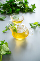 Green tea from currant leaves and mint in a glass container