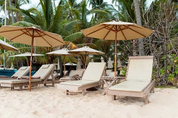 Beach lounger with an umbrella for sunshade