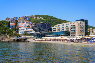 Plaža Ričardova Glava (Richard's Head Beach) overlooked by modern hotels near the Old Town of Budva on the coast of the Adriatic Sea in Montenegro