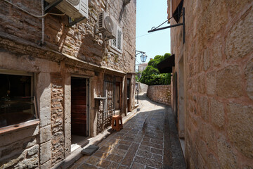 Narrow paved street in the Old Town of Budva, a walled coastal city built by the Venetian Republic along the coast of the Adriatic Sea in Montenegro