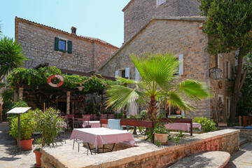Restaurant terrace in the Old Town of Budva, a walled coastal city built by the Venetian Republic along the coast of the Adriatic Sea in Montenegro