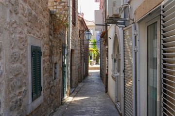 Narrow paved street in the Old Town of Budva, a walled coastal city built by the Venetian Republic along the coast of the Adriatic Sea in Montenegro