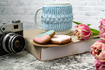Pink tulips, an open book and a mug of freshly brewed coffee or tea. Spring set. Flatley layout.