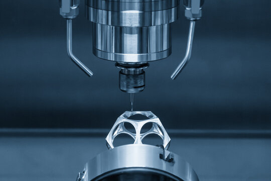 The 5-axis CNC milling machine  cutting the aerospace part with solid ball end mill tool in the light blue scene.