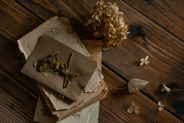 Bouquets of dried flowers with old vintage book on wooden nostalgic vintage background