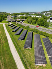 Aerial drone photo of photovoltaic solar panels next to the highway