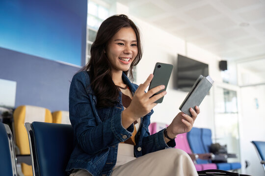 Journey joy with woman using smartphone and wallet in bright airport setting