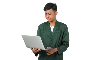 Focused young college student standing using laptop isolated background