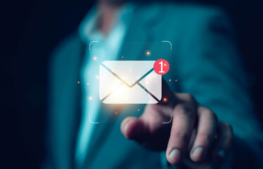 New email notification concept, business online communication, email communication, digital marketing, businessman responding to floating digital interface showing new email notification symbol.	