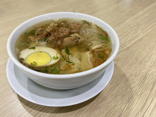 Timlo Soup is Authentic from Solo, Central Java, Indonesian. Made from Chicken, glass noodles, egg, Sosis Solo and Served with hot Clear Chicken Broth. Served on white Bowl.