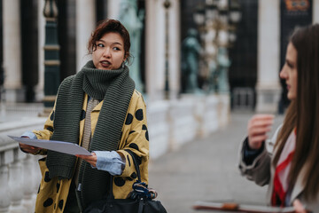 Two individuals in an outdoor urban environment having a discussion and sharing ideas. One holds...