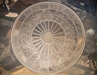 Naklejka premium Participants gather around a beautiful stone compass to honor the summer solstice festivities.