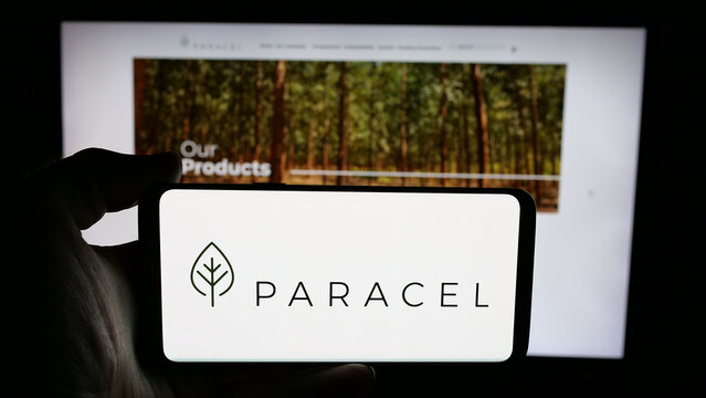 Stuttgart, Germany - 05-04-2025: Person holding cellphone with logo of pulp and paper company Paracel S.A. on screen in front of webpage. Focus on phone display.