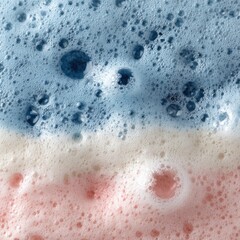Fototapeta premium Close-up of layered foam texture in blue white and pink colors abstract view soap bubbles background