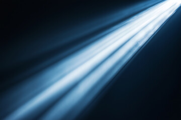 blue light shining on a dark background. The light is coming from the left side of the image