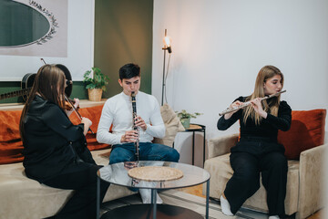 Three musicians gather and play various instruments, including a clarinet, flute, and violin, in a cozy living room ambiance with relaxed seating.