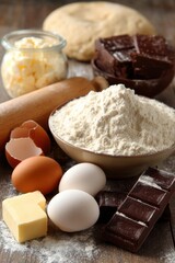 Fototapeta premium Baking Ingredients Still Life Close-Up on Rustic Wood Surface: Flour, Eggs, Chocolate, Butter, Dough, Rolling Pin for Cookbook Recipe Preparation