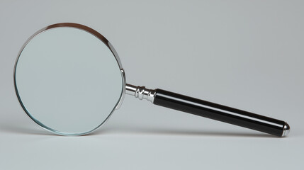 Fototapeta premium Magnifying glass on neutral background, a study in focus and precision