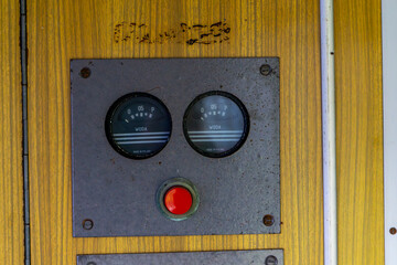 Vintage control panel with two analog water level gauges labeled in Polish and a prominent red...