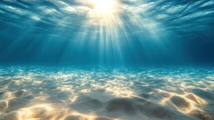 Sunbeams piercing ocean depths, illuminating sandy bottom