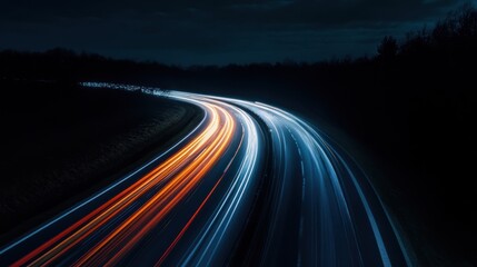 Dynamic light trails illuminate a curving road under the cloak of nightfall