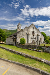 Church of Moulis standing tall under a blue sky in Ariege, France