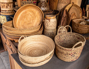 Traditional Egyptian handcrafts like woven baskets and carved wooden items displayed in a market.