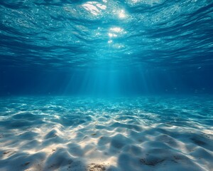 Fototapeta premium Stunning Underwater Scene Blue Ocean, Light Rays, and Sandy Seabed