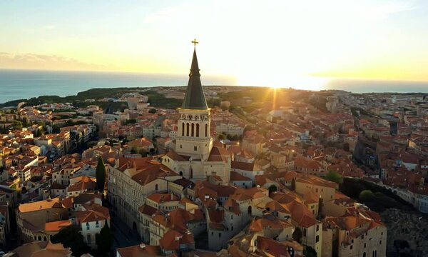 Aerial shot of the city of Marseille, France at sunrise. Basilique Notre-Dame de la Garde on top of hill - landscape panorama of Europe drone view