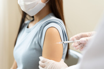 Naklejka premium Health care, corona virus, hand of woman nurse, doctor giving syringe vaccine, injection dose on arm sick patient at clinic. Vaccination, immunization disease prevention against flu pandemic influenza