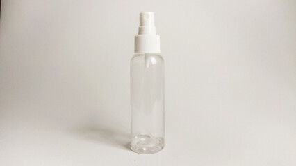 Clear plastic spray bottle with a white nozzle, standing upright on a plain white background. Ideal...