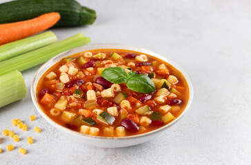 Italian Minestrone soup with ingredients for cooking on white background. Italian, Mediterranean cuisine.