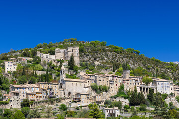Fototapeta premium Montbrun les Bains medieval village rising on a hill in Drome, France