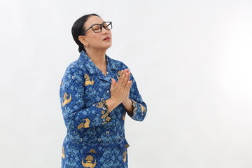 Indonesian civil servant woman praying and begging for something