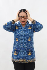 Stressed Indonesian civil servant woman standing while holding her head