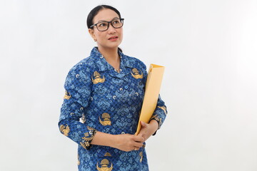 Pretty young Indonesian civil servant standing while holding map