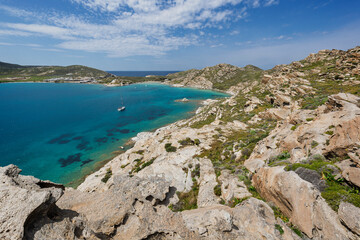 Obraz premium Rocky, lush and hilly landscape and the Aegean Sea at the Paros Park on Paros island in Greece viewed from above on a sunny day.