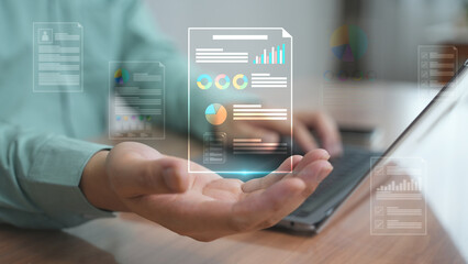 A futuristic data interface with graphs and charts floating above an open palm representing big data, business analytics, and digital management.