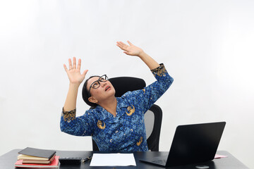 Portrait of Asian civil servant woman looking up and holding hands while looking up into empty...