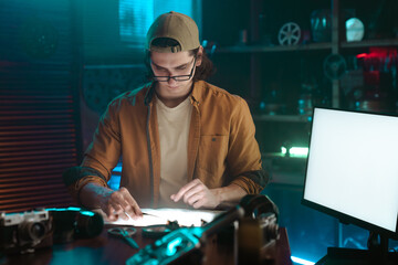 Young man focused on designing at a modern creative workspace
