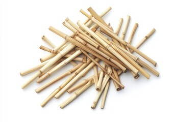 A heap of light brown, slender bamboo or reed stalks, arranged randomly on a white background.  Small, cylindrical pieces of natural material, likely for craft or decorative use