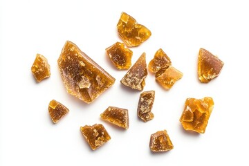 Scattered pieces of golden brown, hard candy